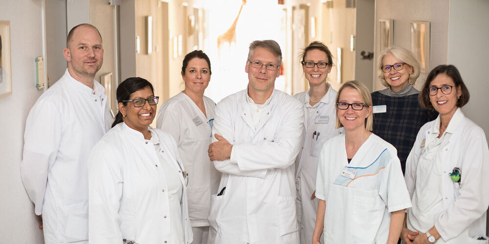 Teambild der Kinderklinik. Auf diesem sind die fünf Ärztinnen und Ärzte, zwei Krankenpflegerinnen und eine Verwaltungskraft vertreten.